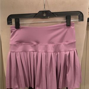 Brand New.  Never worn Gold Hinge plum pleated tennis skirt.  Size small.